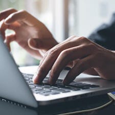 Man typing with GO NFC PAD Reader on the side