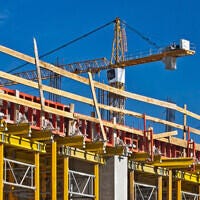 Under construction building with tower crane