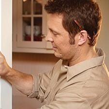 Technician mounting thermostat on the wall