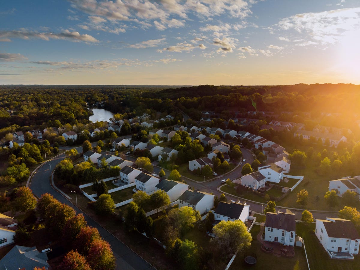 Dawn in the sleeping area of a small town with a forest on the background. View from a height