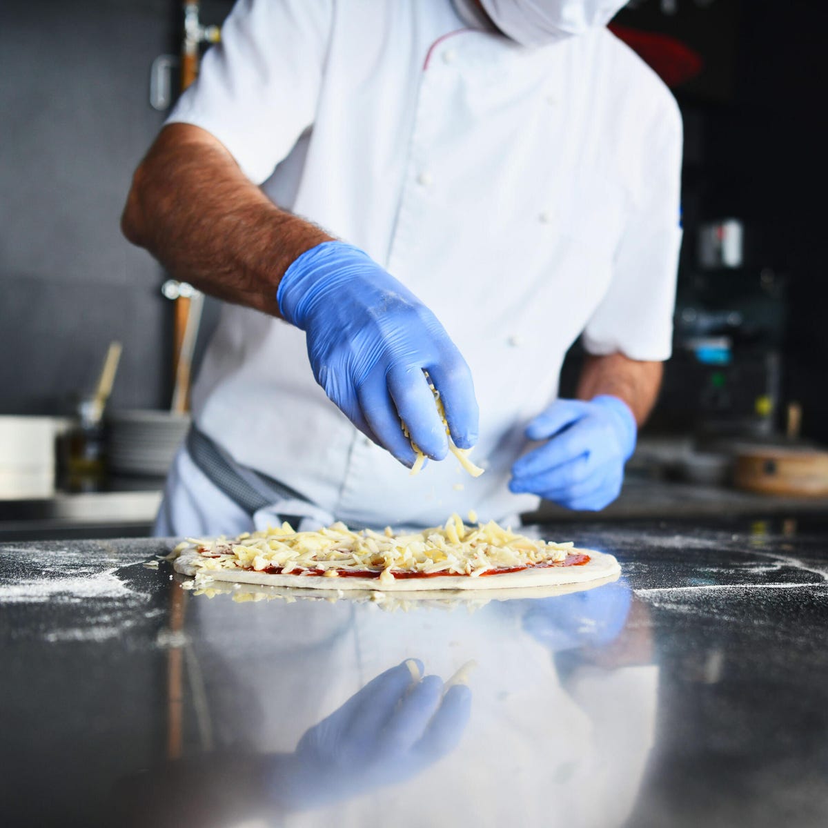 Chef prepping pizza