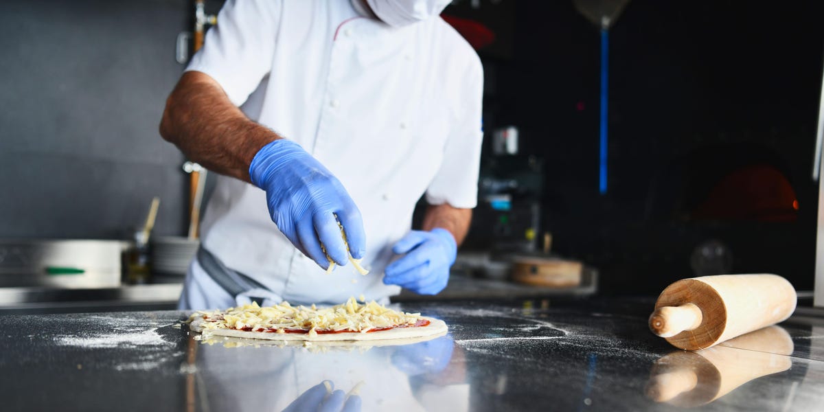 Chef prepping pizza