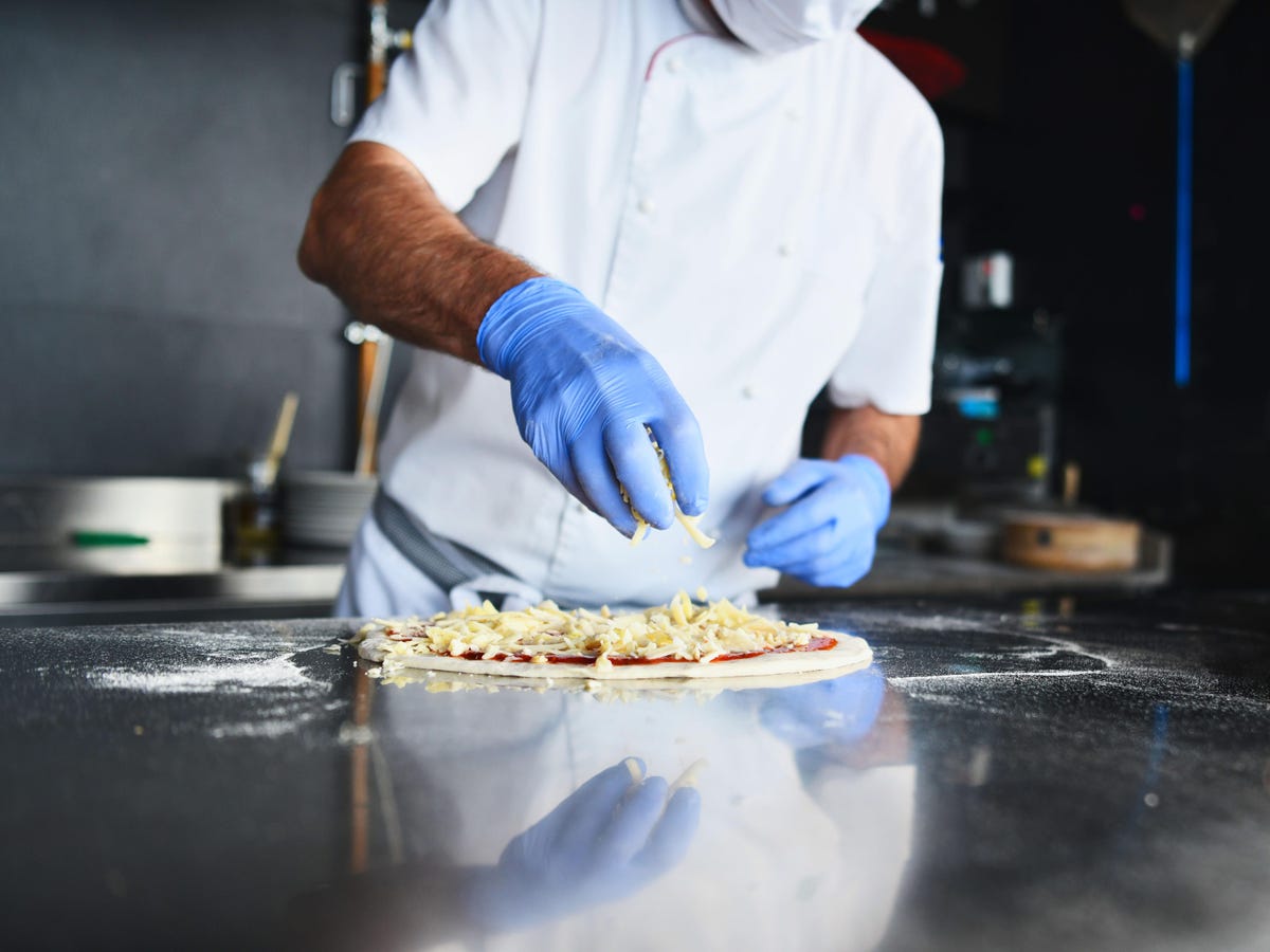 Chef prepping pizza