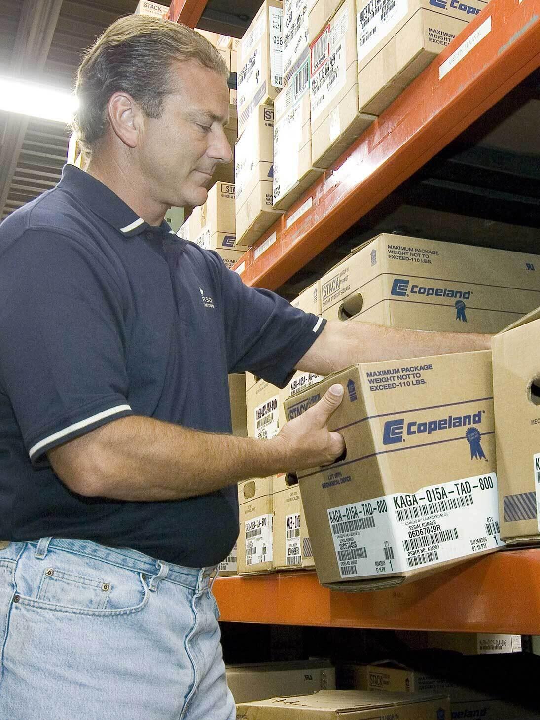 Wholesaler putting a box of Copeland product on the shelf