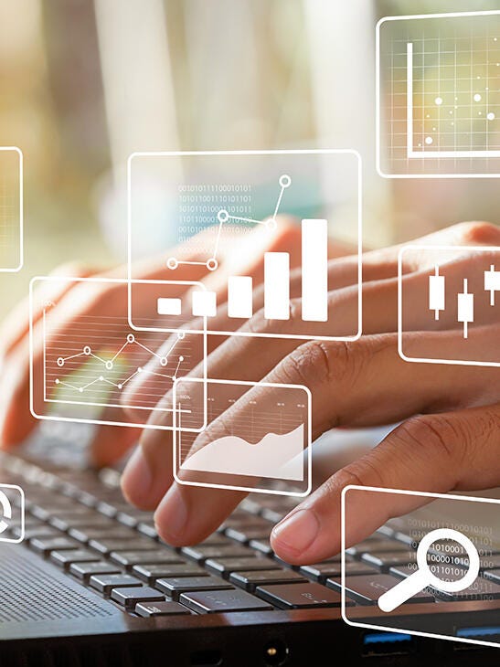 close up of fingers typing with different graphs overlay