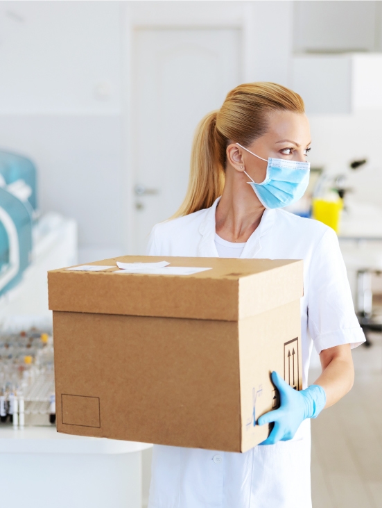 Female health technician holding a box