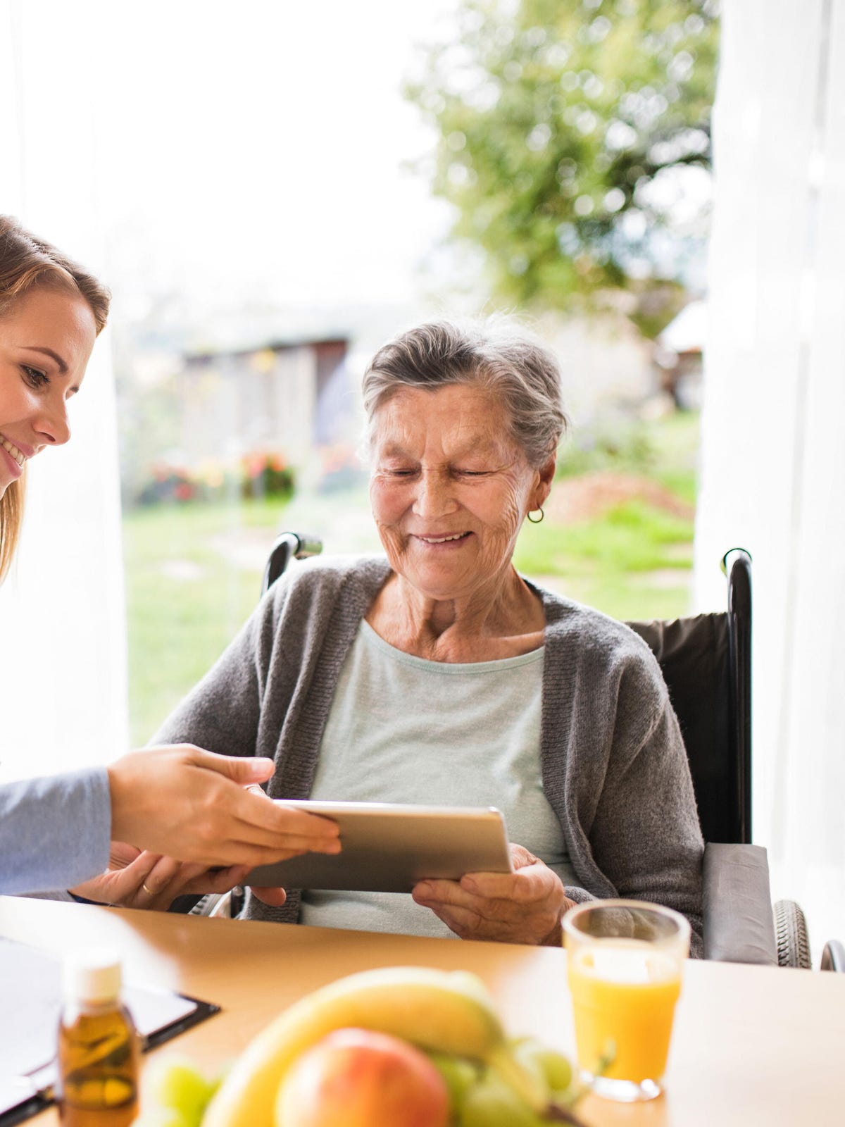 Nurse with senior patient and tablet Nurse with senior patient and tablet