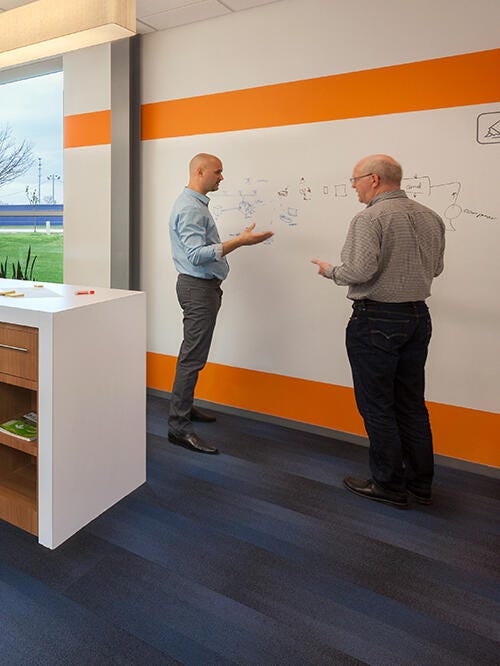 Two men standing having discussions