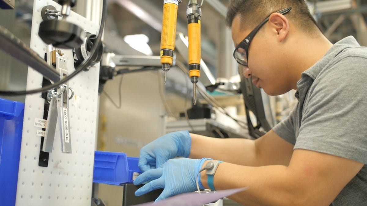 Technician with googles and gloves doing some repair