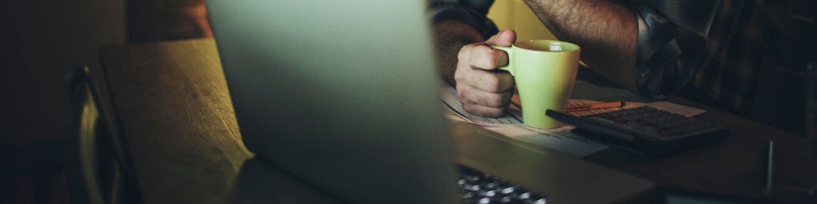 Man facing his laptop