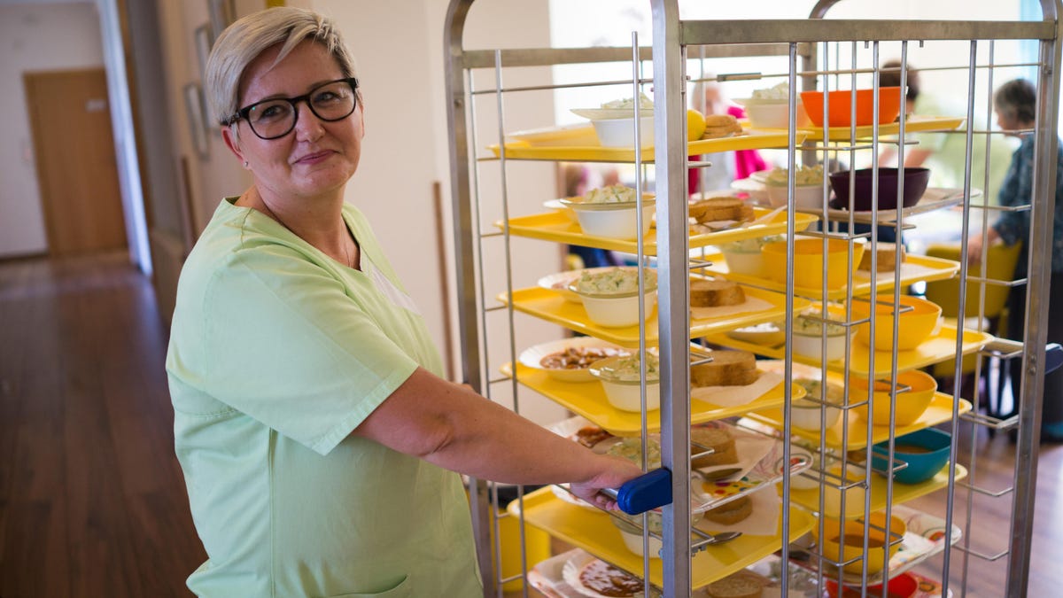 Nurse with meal trays