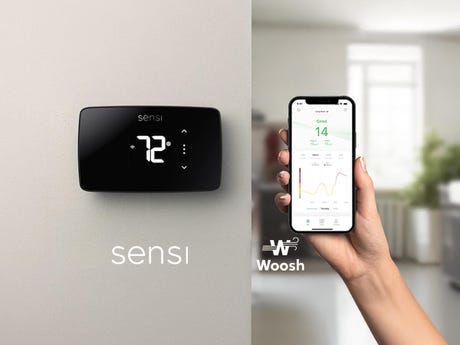 A Sensi Touch 2 smart thermostat next to a smartphone