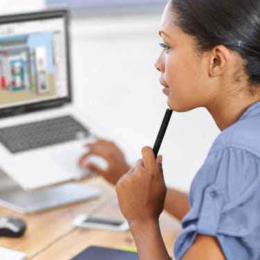 Woman sitting in front of a computer monitor showing the HVACR system