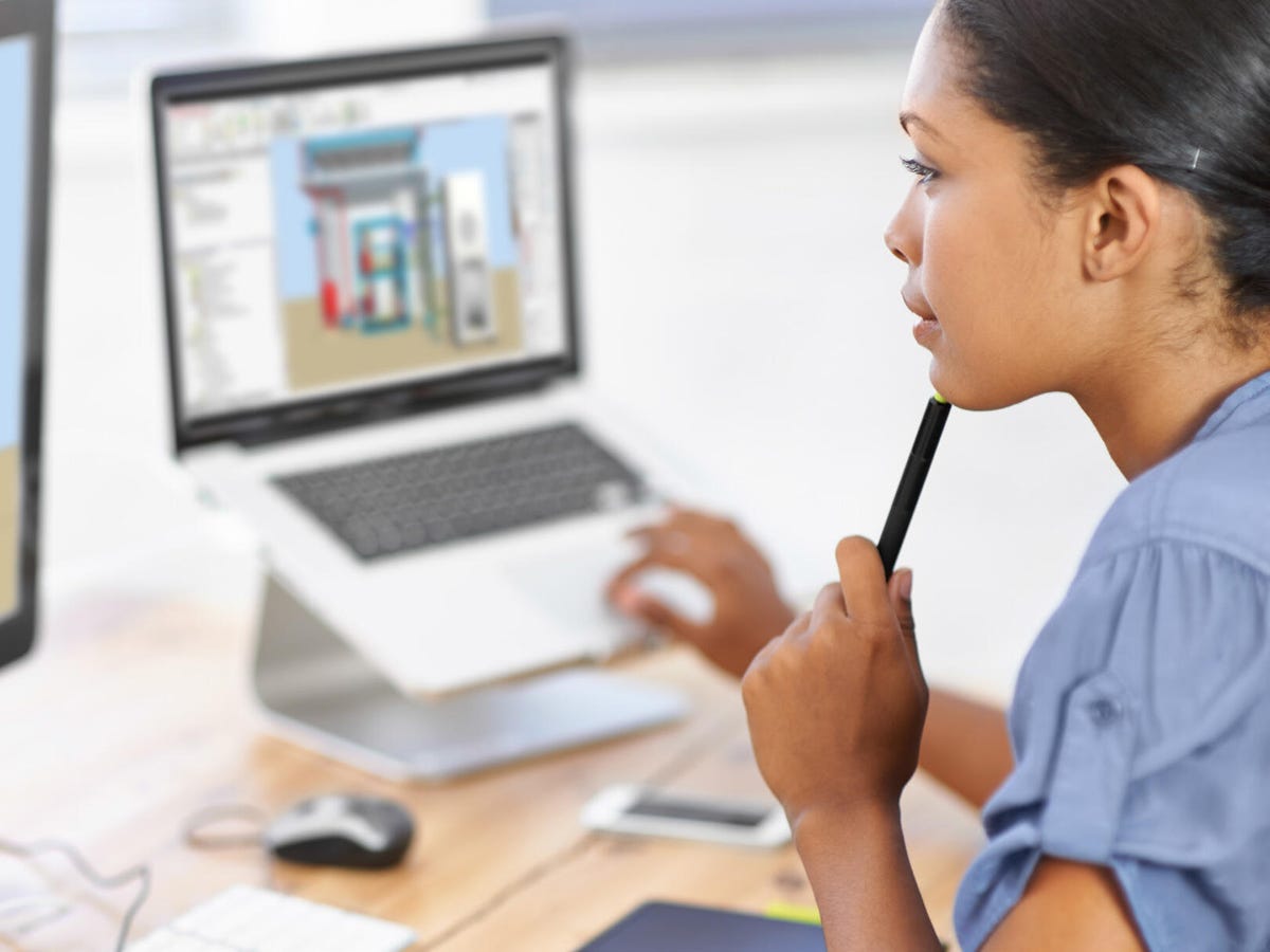 Woman sitting in front of a computer monitor showing the HVACR system