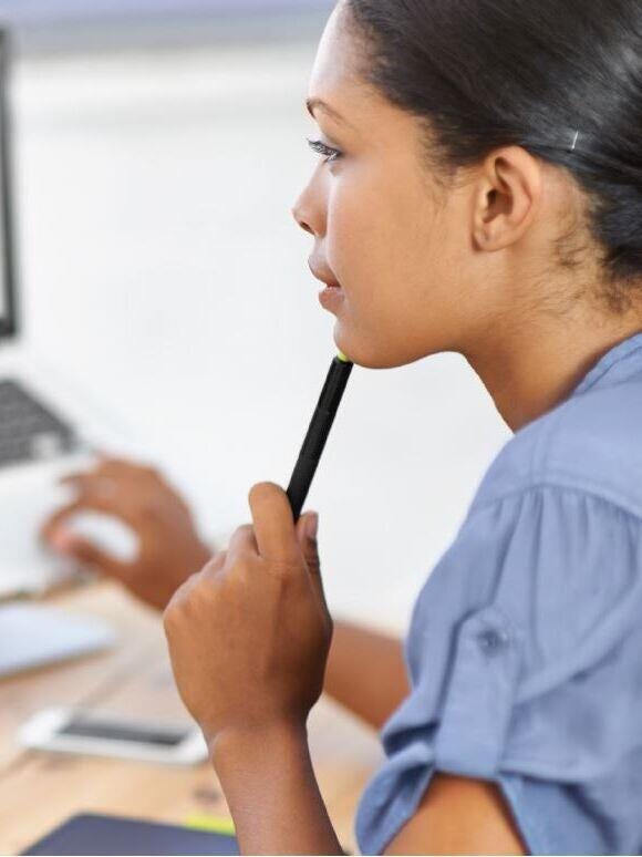 woman facing her laptop