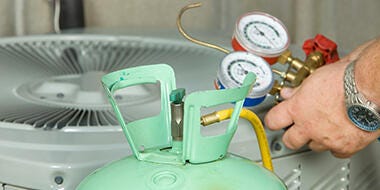 Close up of a refrigerant tank and pressure gauge