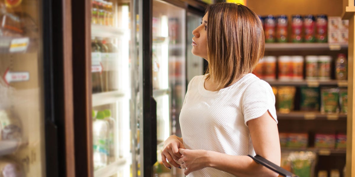 woman in front of a commercial chiller