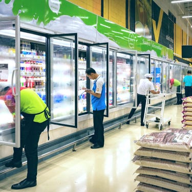 supermarket employees restocking products