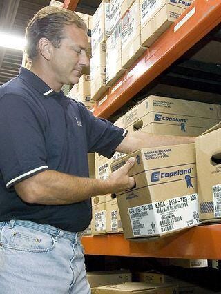 Man piling boxes of Copeland product