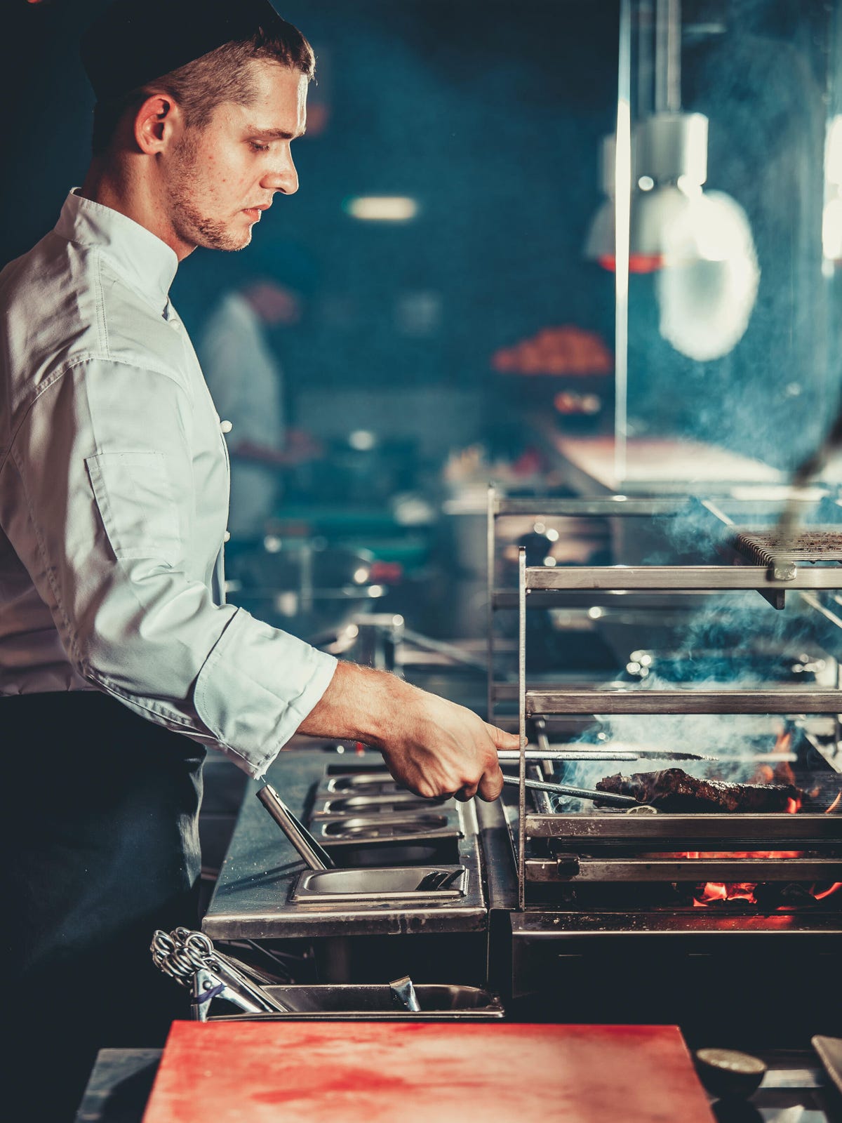 Chef roasting meat side view