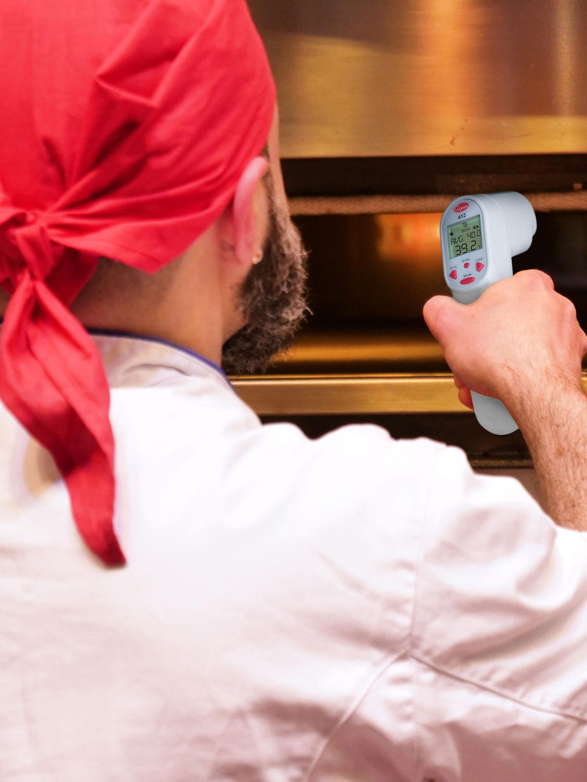 Chef with Infrared thermometer pizza oven