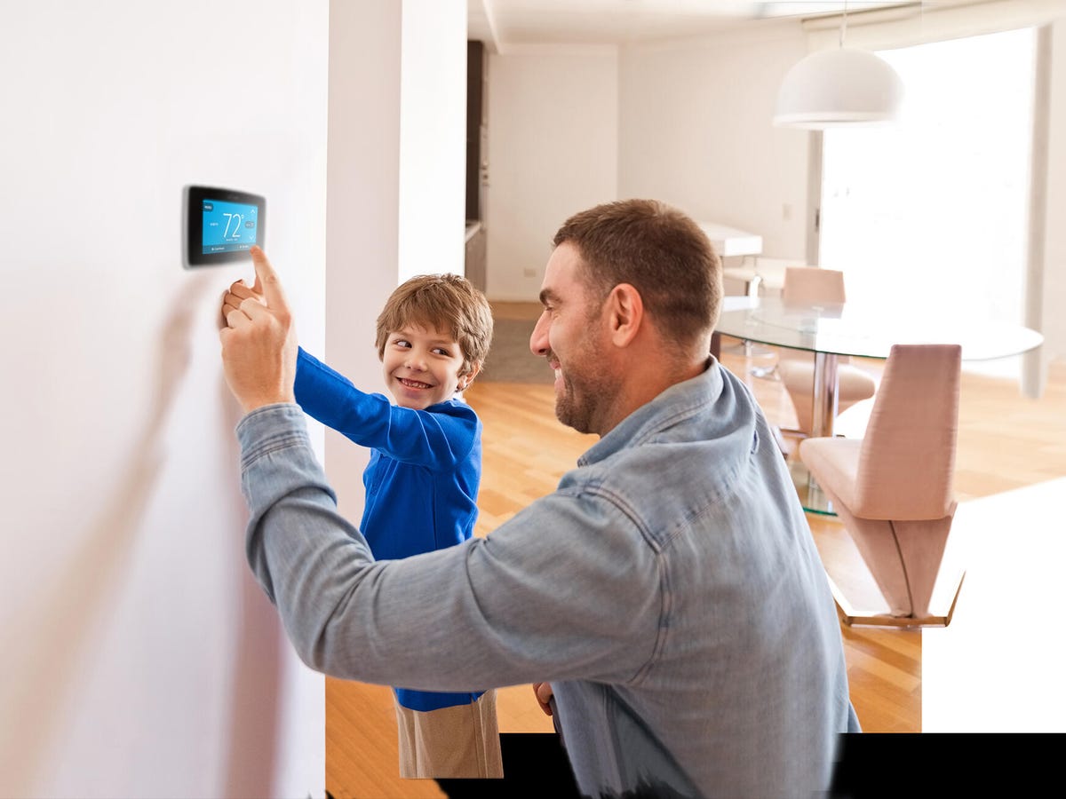 Dad and son setting the thermostat