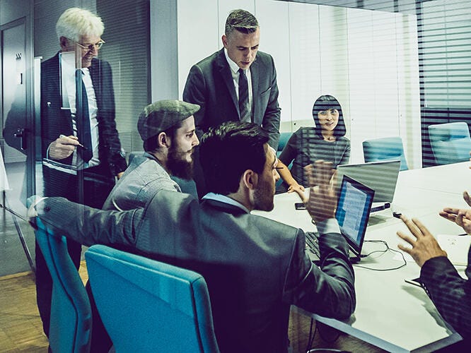 Employees having discussions in a meeting