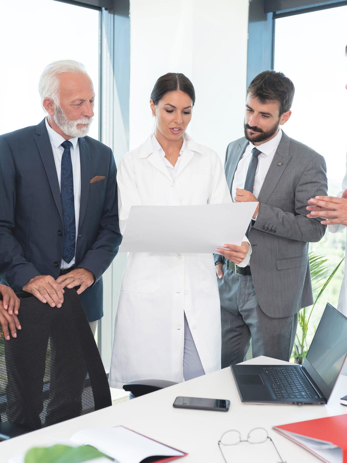 Doctors and business people consulting standing