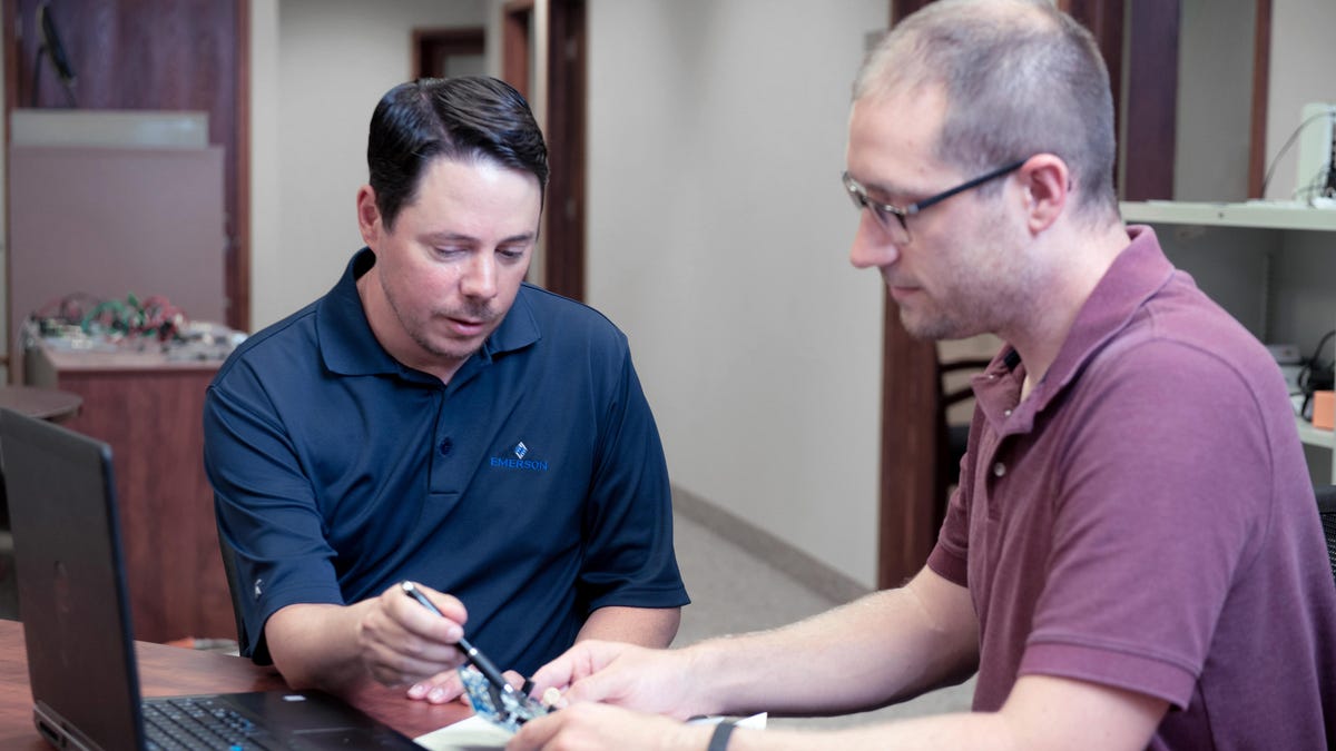 Two men discussing about control board