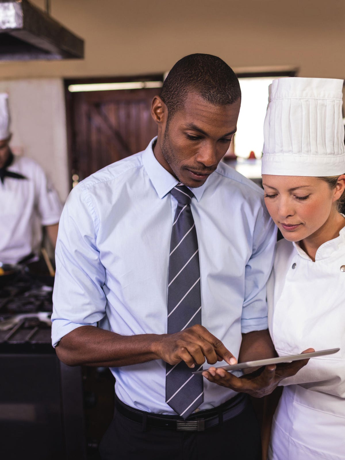 Manager and chef with tablet