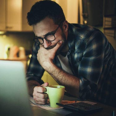 man facing his laptop