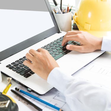 Male Hands Typing On A Laptop Keyboard